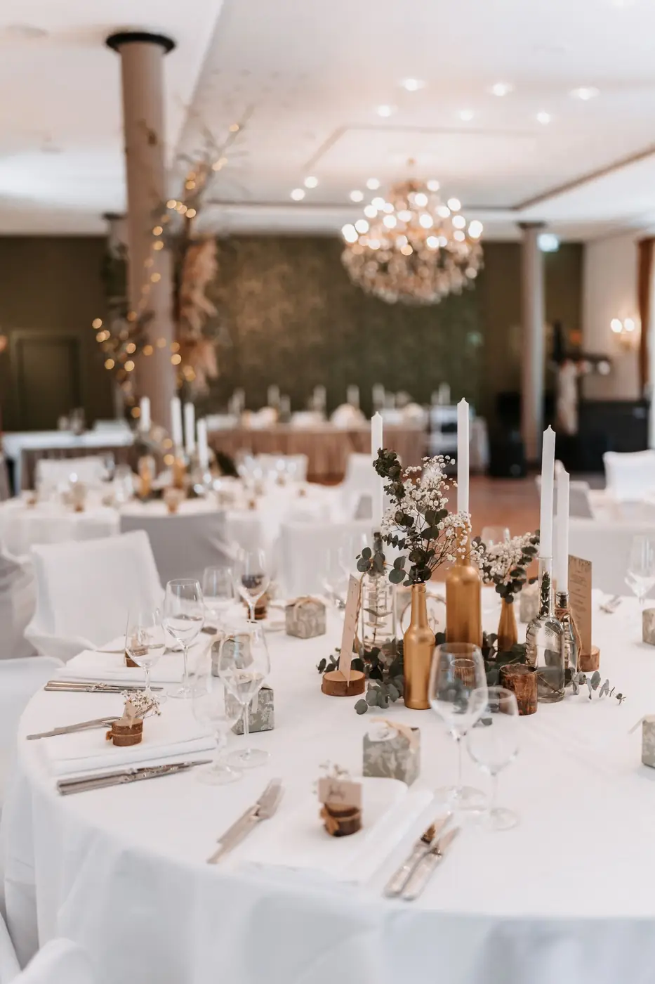 Chic wedding reception setup with elegant table decorations and ambient lighting.