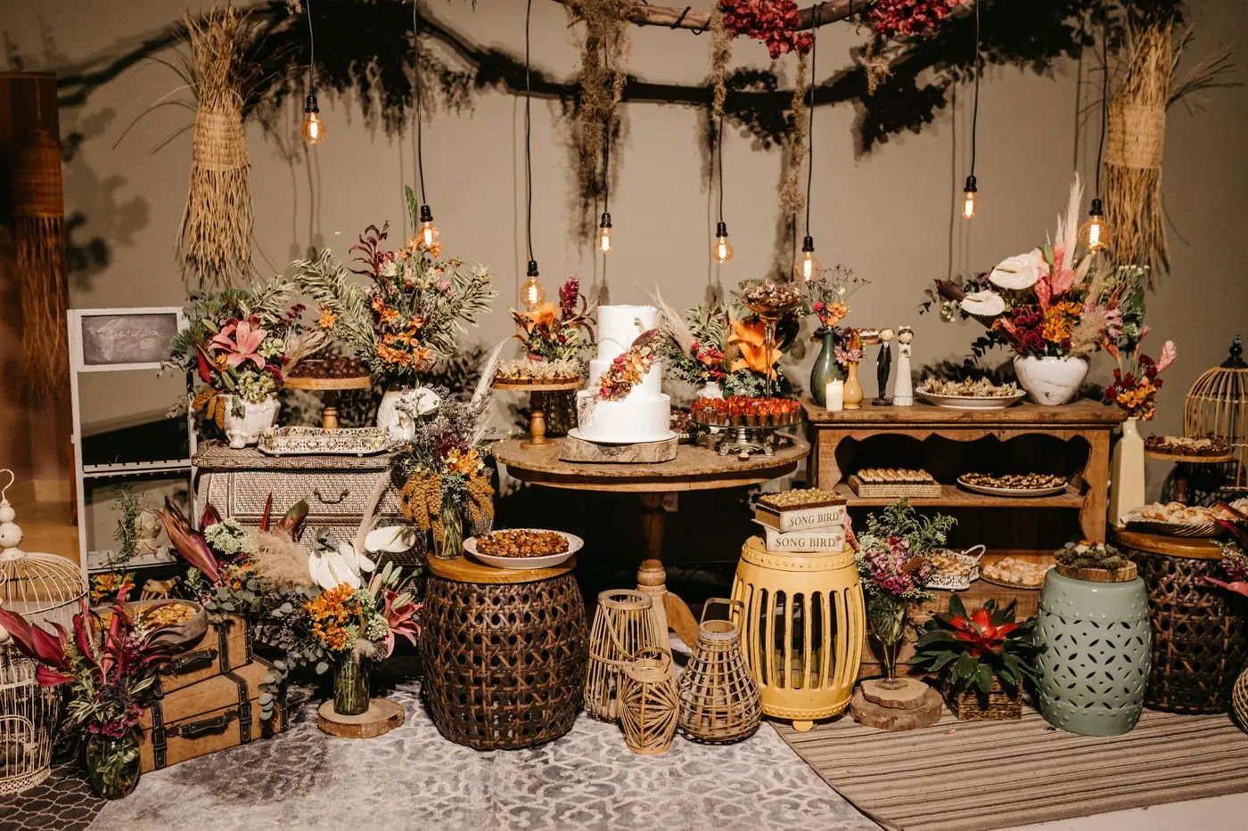 Charming rustic wedding reception with flowers, cake, and vintage decor beautifully arranged.