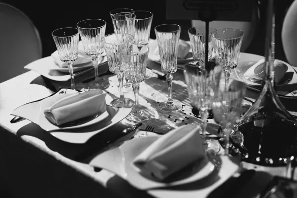 Stylish wedding reception table setup in a Chicago loft with candles and greenery.