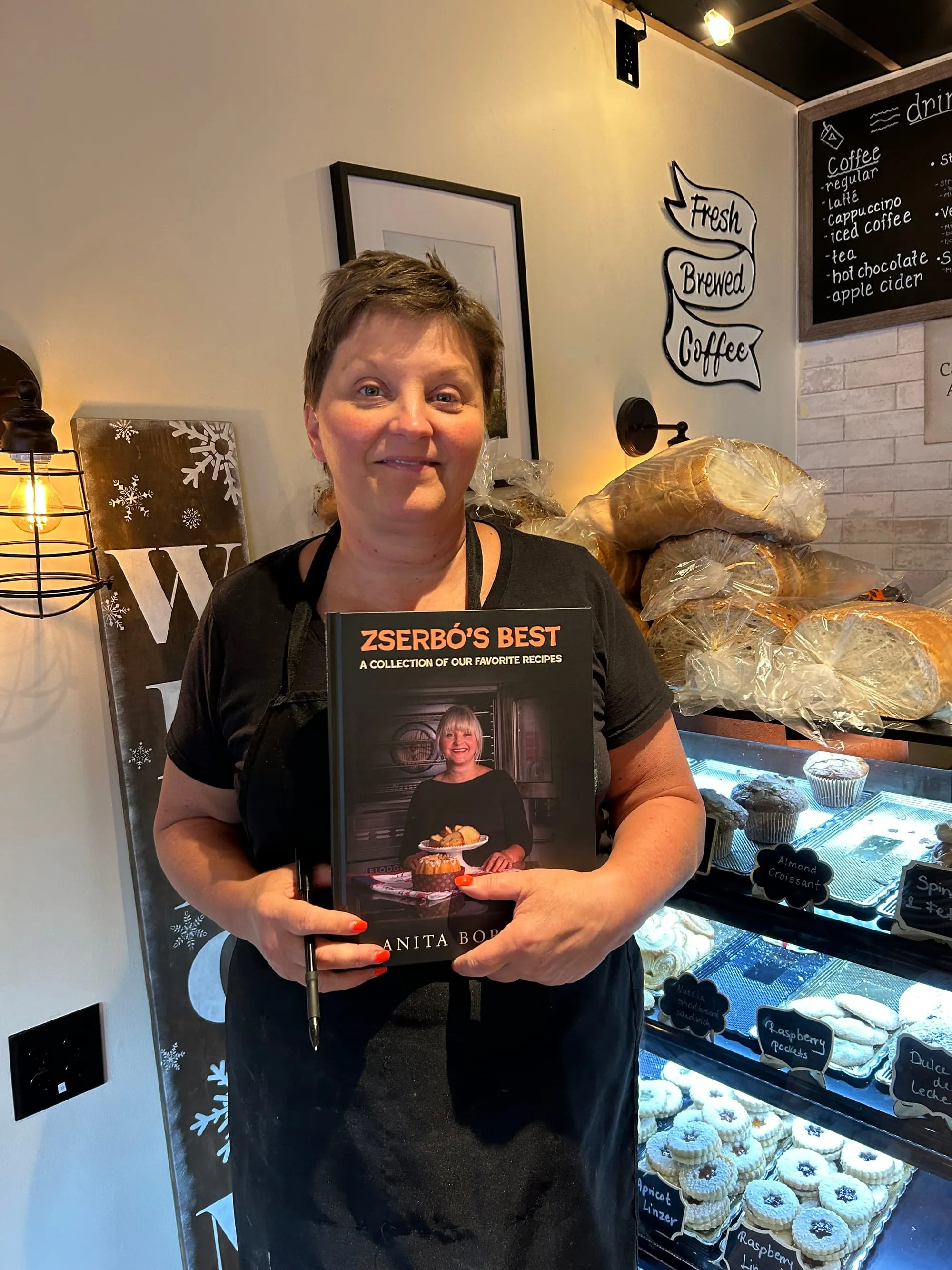 Anita Borbely with her book, "Zserbo's Best" - photo by Donna Daley Brown
