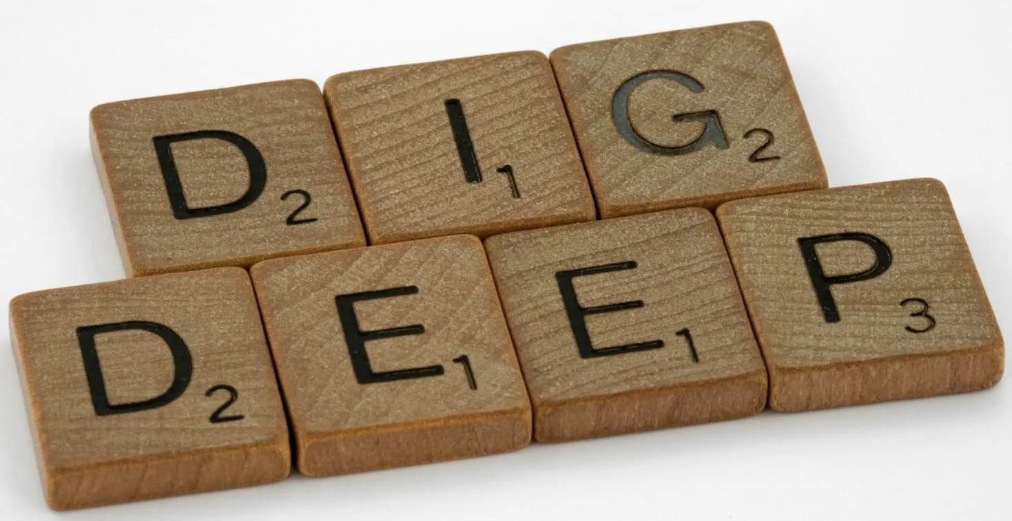 a set of scrabble tiles spelling the word dig deep