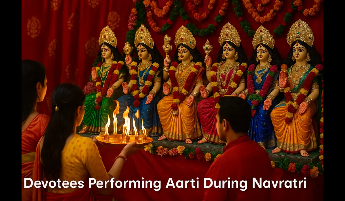 Devotees performing aarti during Navratri in front of Durga idol