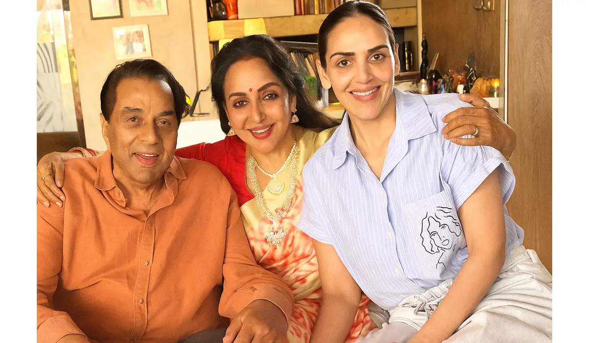Dharmendra Is Stable and Recovering, Confirms Esha Deol and Hema Malini Dharmendra, Hema Malini, and Esha Deol smiling together in a cozy family photo taken indoors.