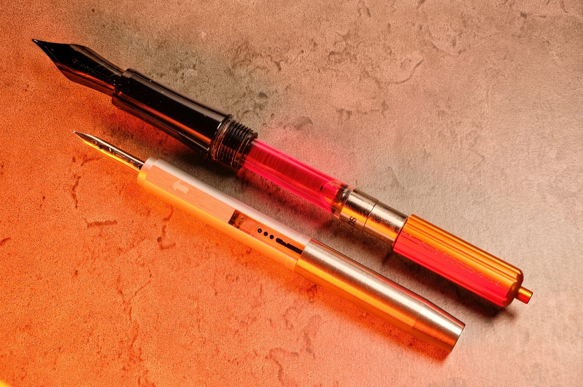 Photo of the nib units & converters for the Endless Captiva & Creator on a faux-marble background