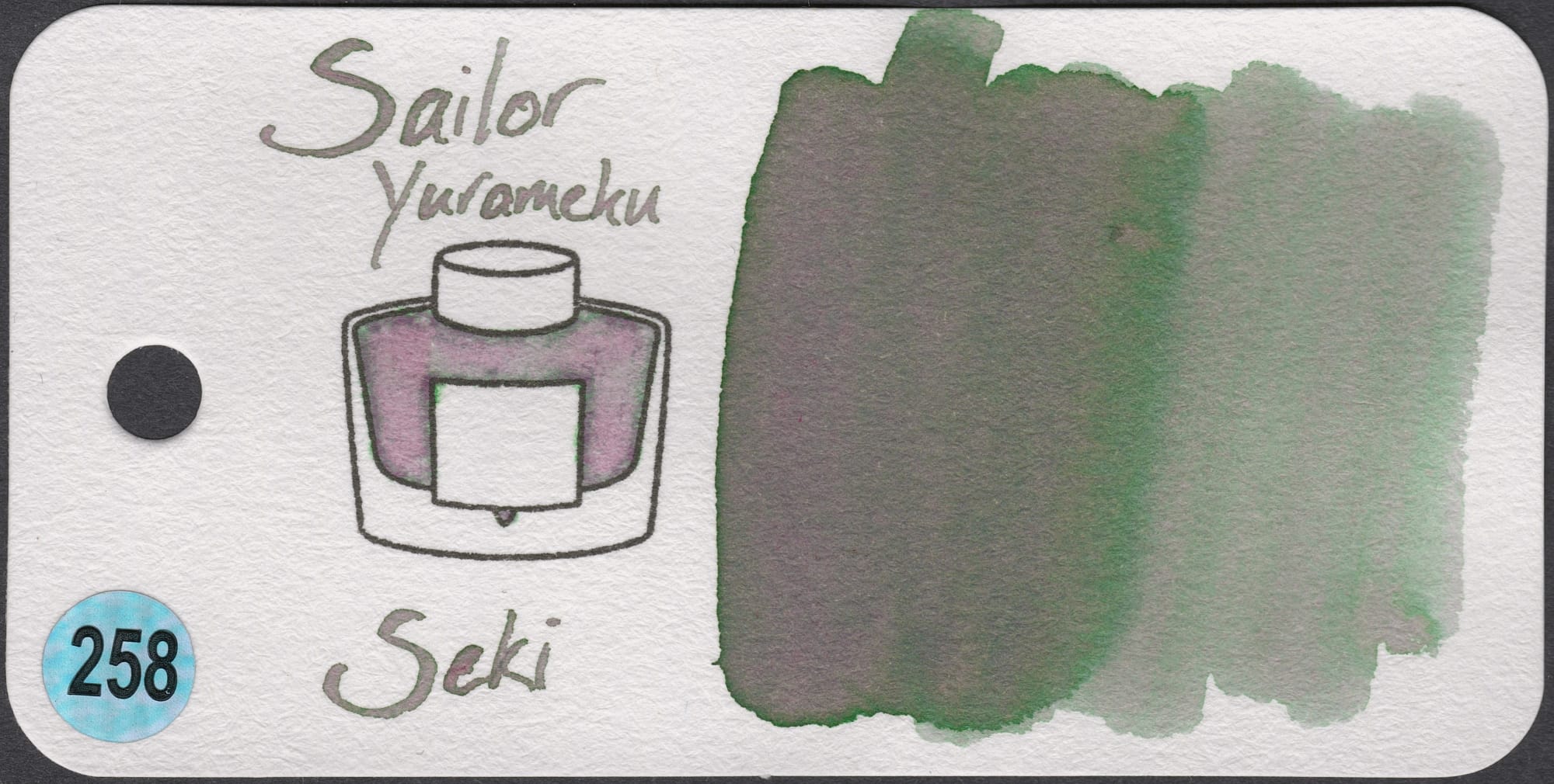 An ink swatch of Sailor Yurameku Seki, a grey chromashading ink with pink & green tones showing through.