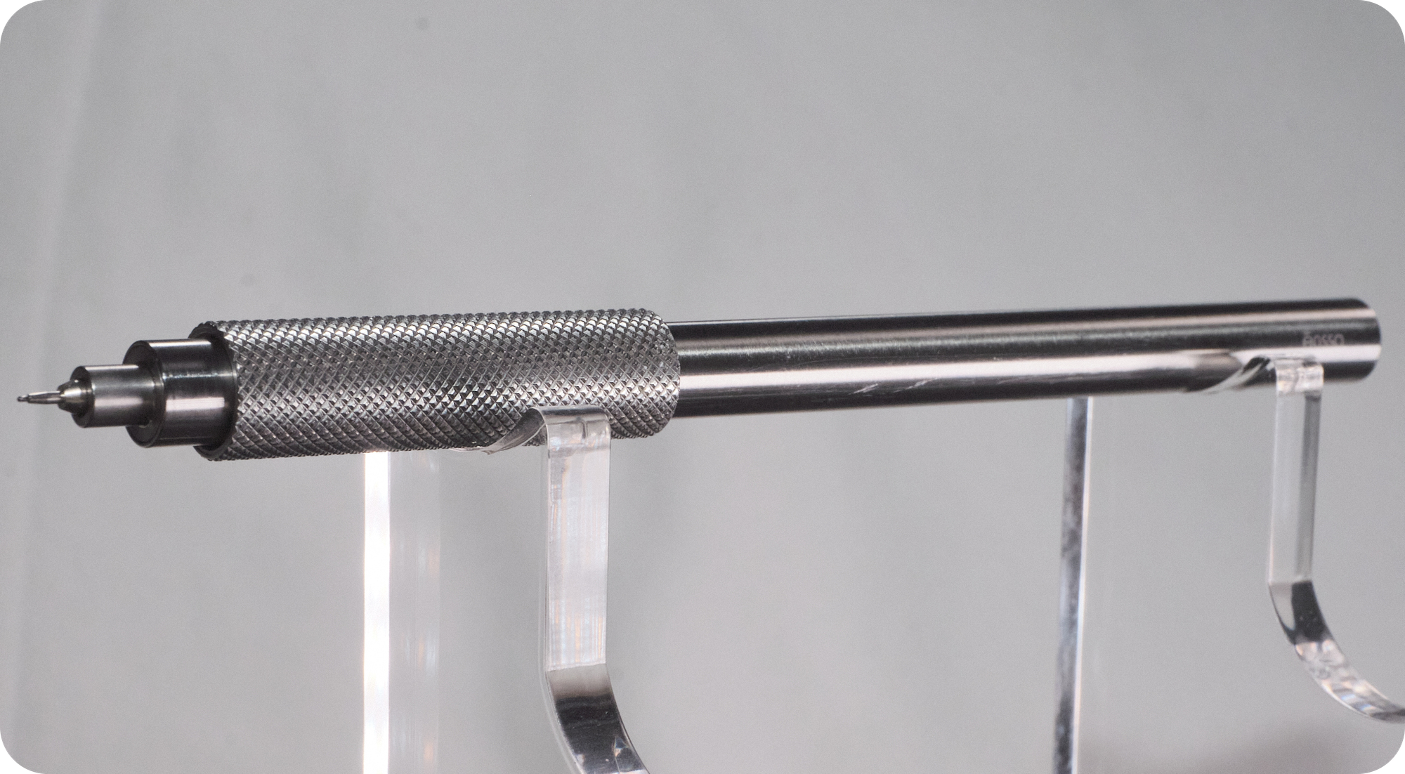 An Ensso Uno XL rollerball pen on an acrylic stand with a light grey background