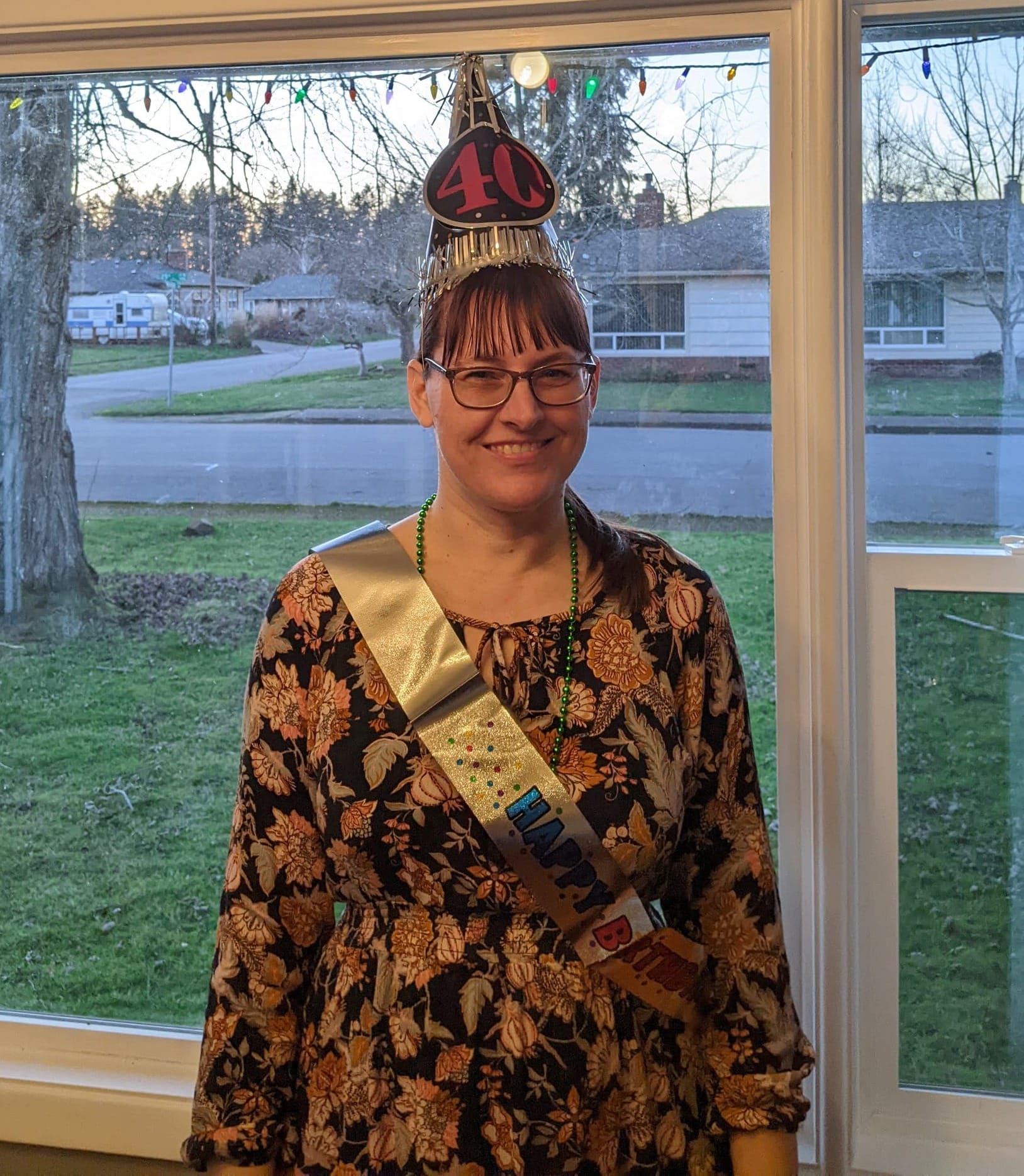 A photo of the author wearing a birthday sash and a party hat that says "40"