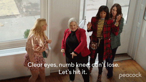 GIF: The four ladies of Girls 5eva walk through a door into a building. One of them is limping and says, through the pain, "Clear eyes, numb knee, can't lose. Let's hit it."