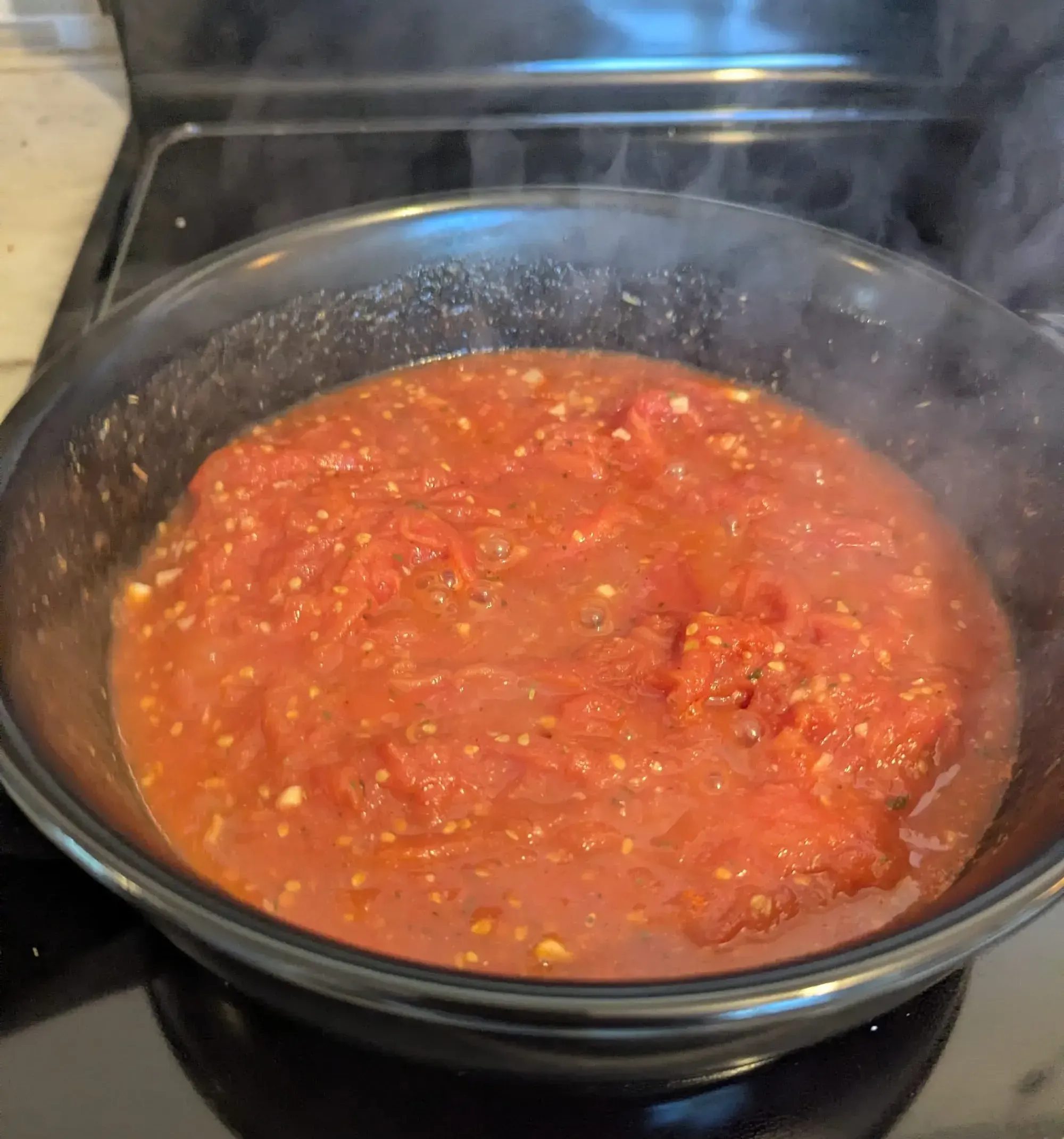 Close-up photo of a bubbling pot of tomato sauce