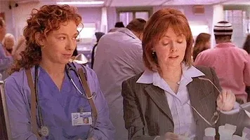 Short GIF of Drs. Corday and Weaver standing together and talking in the ER