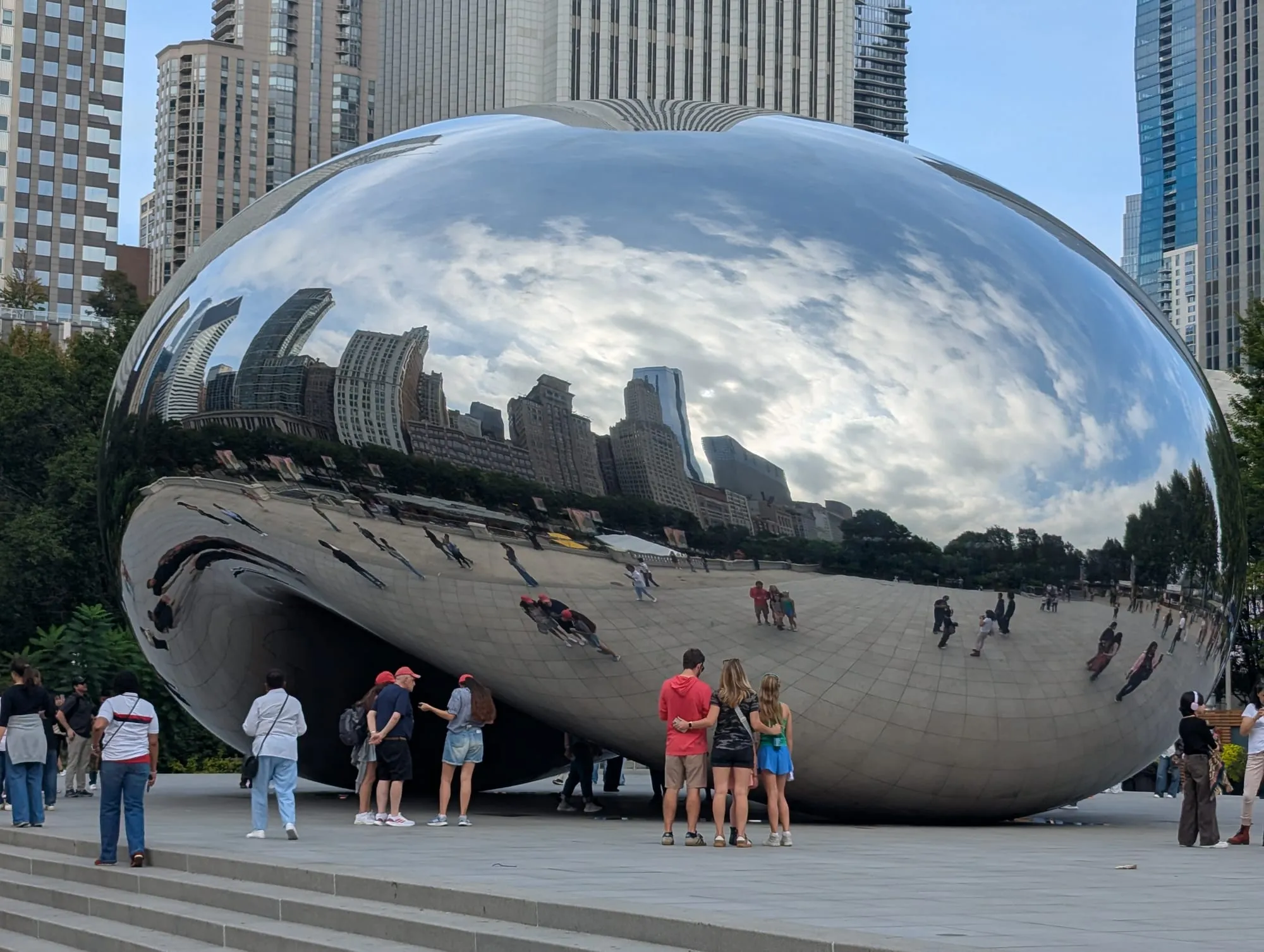 Photo of Cloud Gate, aka The Bean, a giant, reflective chrome sculpture shaped like a bean that reflects the Chicago skyline