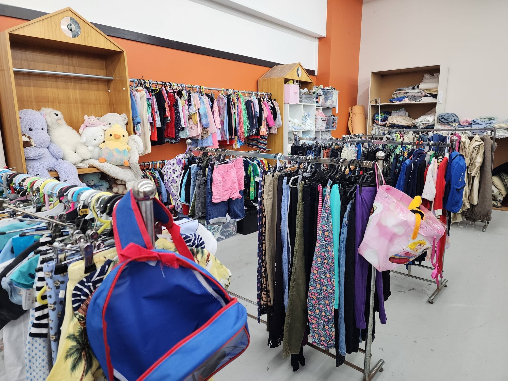 Manny’s Clearance with racks of kids clothes.