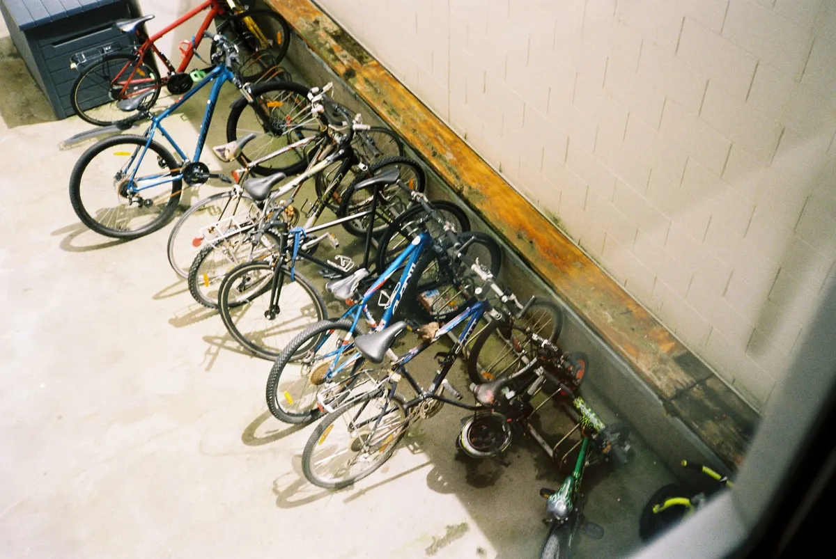 A collection of bikes in a bike rack courtyard.
