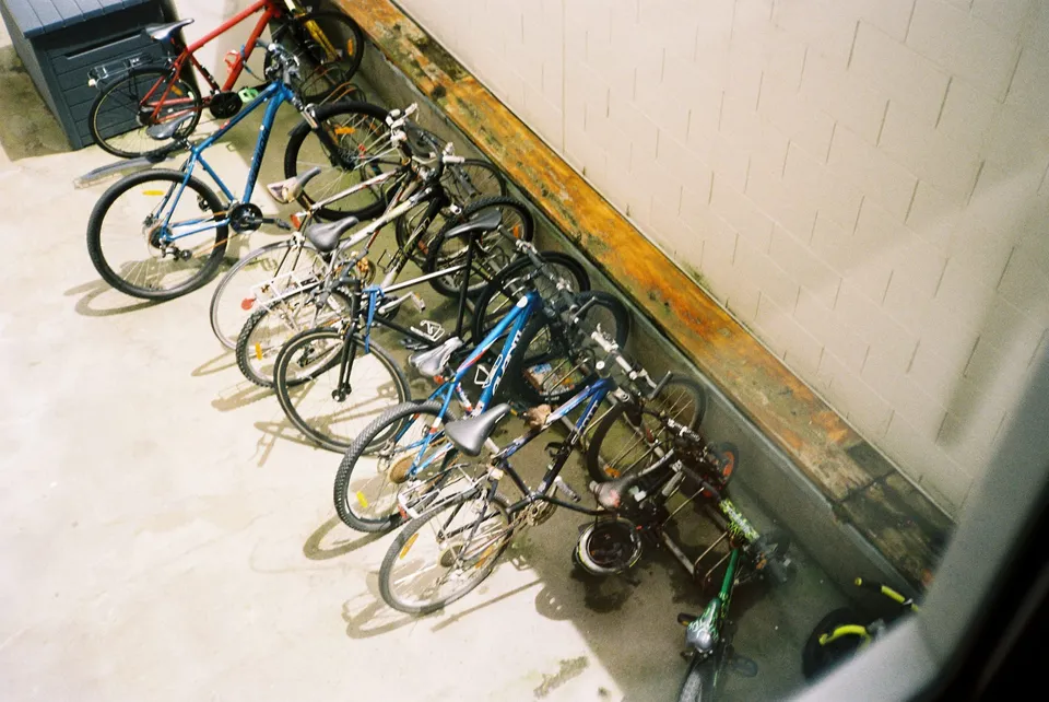 A collection of bikes in a bike rack courtyard.